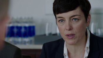 Movie still from “Sabotage” (2014), directed by David Ayer – A person wearing a suit; Close Up shot, Over the shoulder angle