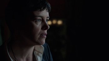 Movie still from “Sabotage” (2014), directed by David Ayer – A person looking at something in the dark; Close Up shot, Over the shoulder angle