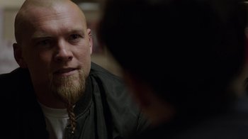 Movie still from “Sabotage” (2014), directed by David Ayer – A man with a beard and a jacket on; Close Up shot, Over the shoulder angle