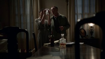 Movie still from “Sabotage” (2014), directed by David Ayer – A man and a woman taking a picture in a room; Medium shot, Over the shoulder angle