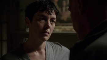Movie still from “Sabotage” (2014), directed by David Ayer – A woman with short black hair looking at a man; Close Up shot, Over the shoulder angle