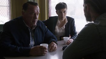 Movie still from “Sabotage” (2014), directed by David Ayer – A man and a woman sitting at a table with drinks; Medium shot, Over the shoulder angle