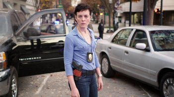 Movie still from “Sabotage” (2014), directed by David Ayer – A woman in a blue shirt is standing on the street; Medium shot, Low angle