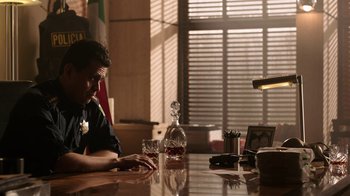 Movie still from “Sabotage” (2014), directed by David Ayer – A man sitting at a table with a glass of wine; Medium shot, Over the shoulder angle