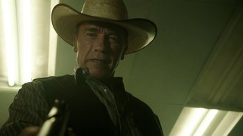 Movie still from “Sabotage” (2014), directed by David Ayer – A man in a cowboy hat holding a gun; Close Up shot, Low angle