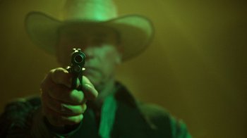 Movie still from “Sabotage” (2014), directed by David Ayer – A man in a cowboy hat is holding a gun; Close Up shot, Low angle