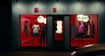 Movie still from “Saint Laurent” (2014), directed by Bertrand Bonello – A store front of a saint laurent store with mannequins in front; Wide shot, Low angle