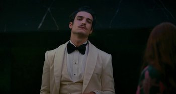 Movie still from “Saint Laurent” (2014), directed by Bertrand Bonello – A man wearing a tuxedo and a bow tie; Close Up shot, Low angle