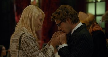Movie still from “Saint Laurent” (2014), directed by Bertrand Bonello – A man and a woman are holding hands; Close Up shot, Over the shoulder angle