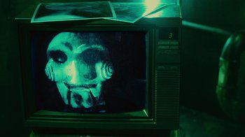 Movie still from “Saw II” (2005), directed by Darren Lynn Bousman – A television with a creepy face on the screen; Extreme Close Up shot, High angle