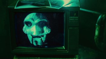 Movie still from “Saw II” (2005), directed by Darren Lynn Bousman – A television with a creepy face on it; Extreme Close Up shot, High angle