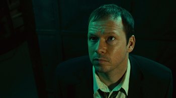 Movie still from “Saw II” (2005), directed by Darren Lynn Bousman – A person wearing a suit and tie; Close Up shot, High angle