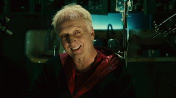 Movie still from “Saw II” (2005), directed by Darren Lynn Bousman – An older man smiling for the camera in a wheelchair; Close Up shot, Low angle