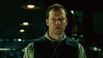 Movie still from “Saw II” (2005), directed by Darren Lynn Bousman – A person wearing a vest; Close Up shot, High angle