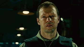 Movie still from “Saw II” (2005), directed by Darren Lynn Bousman – A person wearing a vest; Close Up shot, Over the shoulder angle