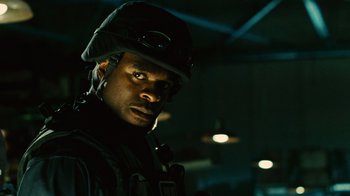 Movie still from “Saw II” (2005), directed by Darren Lynn Bousman – A man wearing a helmet and a black jacket; Close Up shot, Low angle