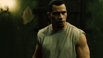 Movie still from “Saw II” (2005), directed by Darren Lynn Bousman – A person wearing a tank top; Close Up shot, Over the shoulder angle