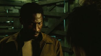 Movie still from “Saw II” (2005), directed by Darren Lynn Bousman – A man and a woman standing next to each other in a room; Close Up shot, Over the shoulder angle