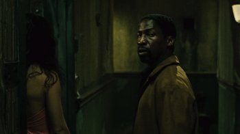 Movie still from “Saw II” (2005), directed by Darren Lynn Bousman – A man standing next to a woman in a dark room; Close Up shot, Over the shoulder angle