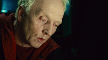 Movie still from “Saw II” (2005), directed by Darren Lynn Bousman – An older woman looking down at the ground; Close Up shot, Low angle