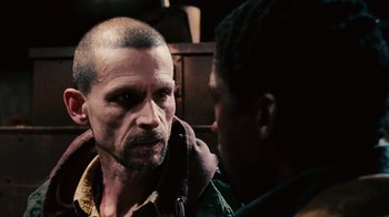 Movie still from “Saw II” (2005), directed by Darren Lynn Bousman – A man is talking to another man who is looking at him; Close Up shot, Over the shoulder angle