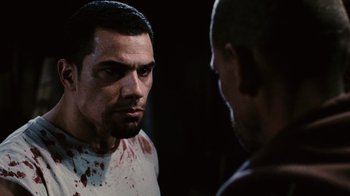 Movie still from “Saw II” (2005), directed by Darren Lynn Bousman – A man looking at himself in the mirror with blood all over his face; Close Up shot, Over the shoulder angle