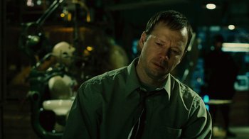 Movie still from “Saw II” (2005), directed by Darren Lynn Bousman – A man in a green dress shirt and black tie; Close Up shot, Low angle