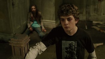 Movie still from “Saw II” (2005), directed by Darren Lynn Bousman – A young man and a young woman sitting on a wooden bench; Medium shot, Over the shoulder angle