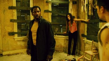 Movie still from “Saw II” (2005), directed by Darren Lynn Bousman – A man and a woman standing next to each other in a room; Medium shot, Low angle