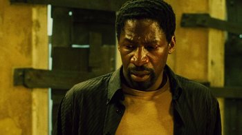 Movie still from “Saw II” (2005), directed by Darren Lynn Bousman – A person wearing a shirt and hat; Close Up shot, Low angle