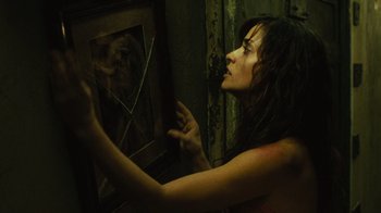 Movie still from “Saw II” (2005), directed by Darren Lynn Bousman – A woman looking into a broken glass window; Close Up shot, Over the shoulder angle