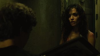 Movie still from “Saw II” (2005), directed by Darren Lynn Bousman – A woman standing in front of a bathroom mirror; Close Up shot, Over the shoulder angle