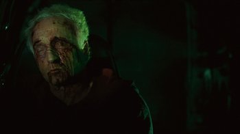 Movie still from “Saw II” (2005), directed by Darren Lynn Bousman – A person with a face covered in blood; Close Up shot, High angle
