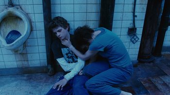 Movie still from “Saw II” (2005), directed by Darren Lynn Bousman – A man and a woman sitting next to each other on the ground; Medium shot, High angle