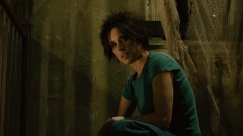 Movie still from “Saw II” (2005), directed by Darren Lynn Bousman – A woman sitting on the ground in front of a tree; Close Up shot, Low angle