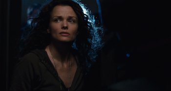 Movie still from “Saw III” (2006), directed by Darren Lynn Bousman – A woman in a black shirt is looking at the camera; Close Up shot, Over the shoulder angle