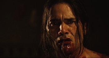 Movie still from “Saw III” (2006), directed by Darren Lynn Bousman – A person with blood on his face; Close Up shot, Low angle