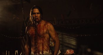 Movie still from “Saw III” (2006), directed by Darren Lynn Bousman – A man with blood all over his face and chest; Medium shot, Low angle