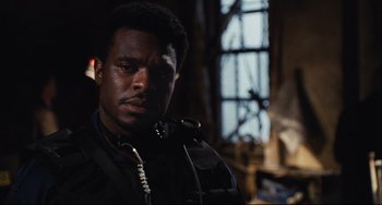 Movie still from “Saw III” (2006), directed by Darren Lynn Bousman – A man in a black jacket is looking at the camera; Close Up shot, Over the shoulder angle