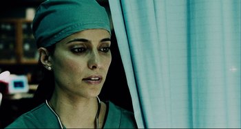Movie still from “Saw III” (2006), directed by Darren Lynn Bousman – A woman in a surgical cap is looking to her left; Close Up shot, Low angle
