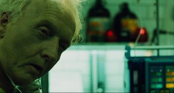 Movie still from “Saw III” (2006), directed by Darren Lynn Bousman – An old man with white hair looking down at his face; Close Up shot, Low angle