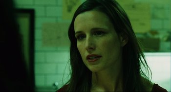 Movie still from “Saw III” (2006), directed by Darren Lynn Bousman – A person with long black hair; Close Up shot, Over the shoulder angle