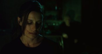 Movie still from “Saw III” (2006), directed by Darren Lynn Bousman – A woman sitting in front of a man in a dark room; Close Up shot, Over the shoulder angle