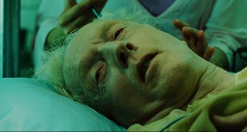 Movie still from “Saw III” (2006), directed by Darren Lynn Bousman – An old man laying in a hospital bed; Close Up shot, Overhead angle