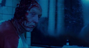 Movie still from “Saw III” (2006), directed by Darren Lynn Bousman – A man with blood all over his face and head; Close Up shot, Over the shoulder angle