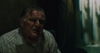 Movie still from “Saw III” (2006), directed by Darren Lynn Bousman – An older man sitting in front of a window; Close Up shot, Low angle