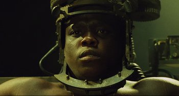 Movie still from “Saw III” (2006), directed by Darren Lynn Bousman – A person with a helmet on; Close Up shot, Low angle