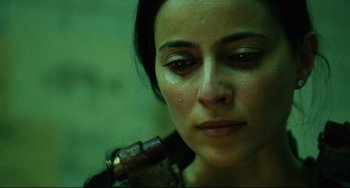 Movie still from “Saw III” (2006), directed by Darren Lynn Bousman – A person holding a gun in a room; Close Up shot, Low angle