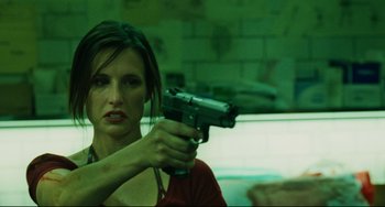 Movie still from “Saw III” (2006), directed by Darren Lynn Bousman – A woman is holding a gun in a room; Close Up shot, Low angle