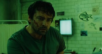 Movie still from “Saw III” (2006), directed by Darren Lynn Bousman – A person with a face covered in blood; Close Up shot, Low angle